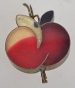 A vintage lucite brass bound figural brooch in the form of an apple with twisted stem clasp.