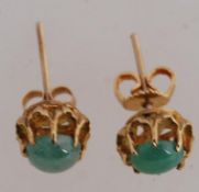 A pair of 9ct gold earrings with prong set green stone with post backs. weight 2g.