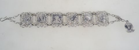 A vintage white metal link bracelet with Japanese, Roman, and Egyptian motif links with hook clasp.