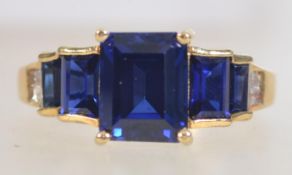 A 925 silver gilt Art Deco style ring set with cushion cut blue and clear stones. Marked 925.