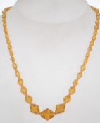 A vintage amber glass bead necklace with spring hoop clasp. Measures 15 inches.