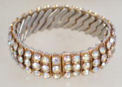 A vintage concertina AB rhinestone set bangle bracelet marked Empire Made.