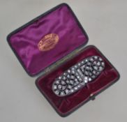A white metal and marcasite style rhinestone brooch with roller clasp. Measures 7 cms.
