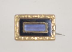 A Victorian mourning brooch with black enamel and yellow metal gallery with c clasp.