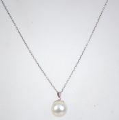 A 925 silver pendant necklace with pearl drop pendant. Measures 16 inches.