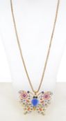 A large enamel and rhinestone set butterfly pendant necklace strung on yellow metal chain.