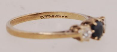 A 9ct gold diamond and sapphire trilogy ring. Hallmarked London. Size M.