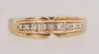 A 9ct gold and diamond ring. Hallmarked London import. Size N.