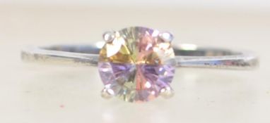 A silver ring set with an unusual four colour quartered CZ stone. Marked 925 CZ size M.5.