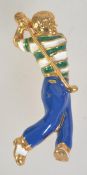 A gold tone enamelled figural brooch pin in the form of a golfer with roller clip clasp.