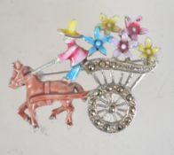 A 1950s enamel and marcasite brooch in the form of a horse and flower cart with rollover catch.