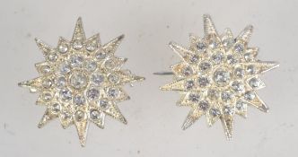 A 1950s pair of silvertone metal and rhinestone scatter pins having loop catches. Both measure 2.