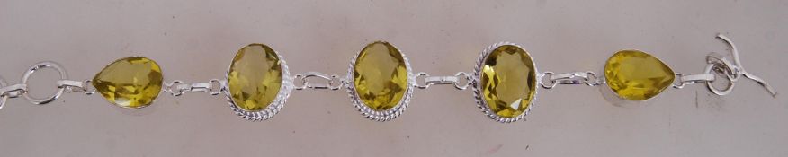 A 925 silver braclet with faceted yellow glass links with toggle clasp.