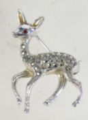 A 1950s silvertone metal and marcasite fawn brooch having rollover catch, measures 3.