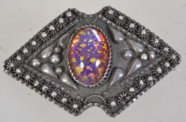 An early 20th century Egyptian silver brooch pin with foil glass cabochon and c clasp.