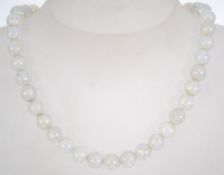 A vintage moonstone bead necklace with spring hoop clasp.