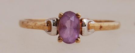 A 9ct gold ring set with a purple gem stone. Marked 9ct. N.5.