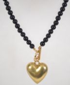 A French jet bead necklace set with a large heart pendant and toggle clasp. Marked Pilgrim.