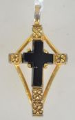 A signed French jet crucifix pendant in a yellow metal mount. Marked Airagle to verso.