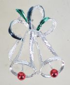A vintage Christmas brooch in the form of two bells in silver tone metal with a rollover catch.