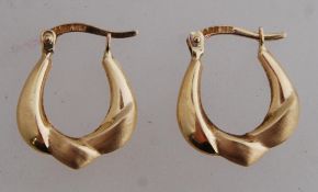 A pair of 14ct gold creole earrings with leaver catch. Marked ARR 14K. tests 14ct gold. Weight 1.3g.