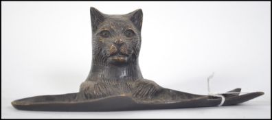 An early - mid 20th century bronze dish in the form of a cat resting upon a fish. Likely a pen dish.