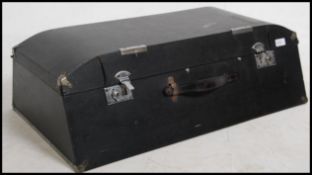 A mid century black angular car motoring