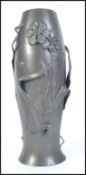 An early 20th century pewter vase embell