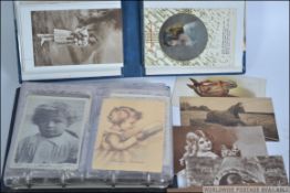 Two 20th century postcard albums contain