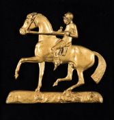 A Regency period gilded brass racehorse & jockey, mounted on velvet within a maple frame,