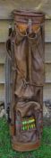 Fine oval leather golf bag, complete with ball pocket, original shoulder strap and travel hood,