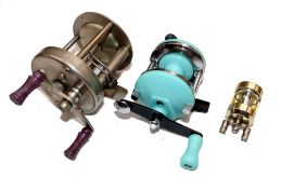 REELS: (3) An Abu Record 1500 multiplier reel in fine condition, twin purple handles, model 