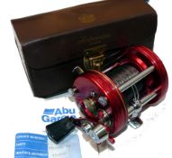 REEL: Abu Ambassadeur 6000 multiplier reel, red grooved end rims, 3 screws, level wind, star drag,