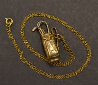 9ct golf bag and golf club charm c/w a yellow metal chain - wt 8.1gms