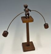 Gravity-Defying Wooden 'Balancing Bear' Austerity Toy a balancing bear upon a pedestal attached to a