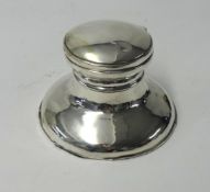 A silver capstan inkwell.