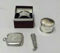 A pair of silver Mappin and Webb serviette rings (one boxed), silver vesta, silver needle case, (