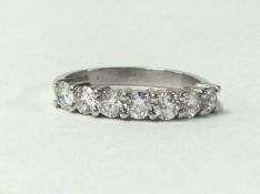 An 18ct white gold seven stone diamond ring, claw set with brilliant cut stones, total weight