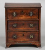 A 19th century mahogany miniature chest of drawers The moulded rectangular top above three drawers