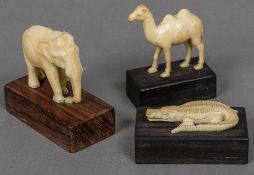 Three small carved ivory models of animals, possibly Indian An elephant, a camel and a crocodile,