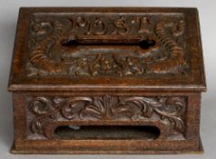 A Victorian carved oak post box The sloping hinged lid inscribed Post above a recess flanked by