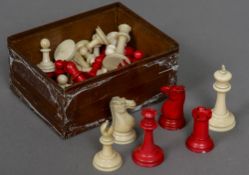 A late 19th/early 20th century carved and red stained Staunton pattern chess set In mahogany box.