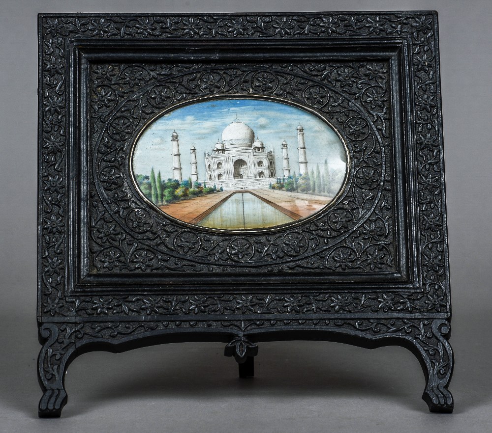 A 19th century Indian miniature on ivory depicting the Taj Mahal Set in a florally carved ebony