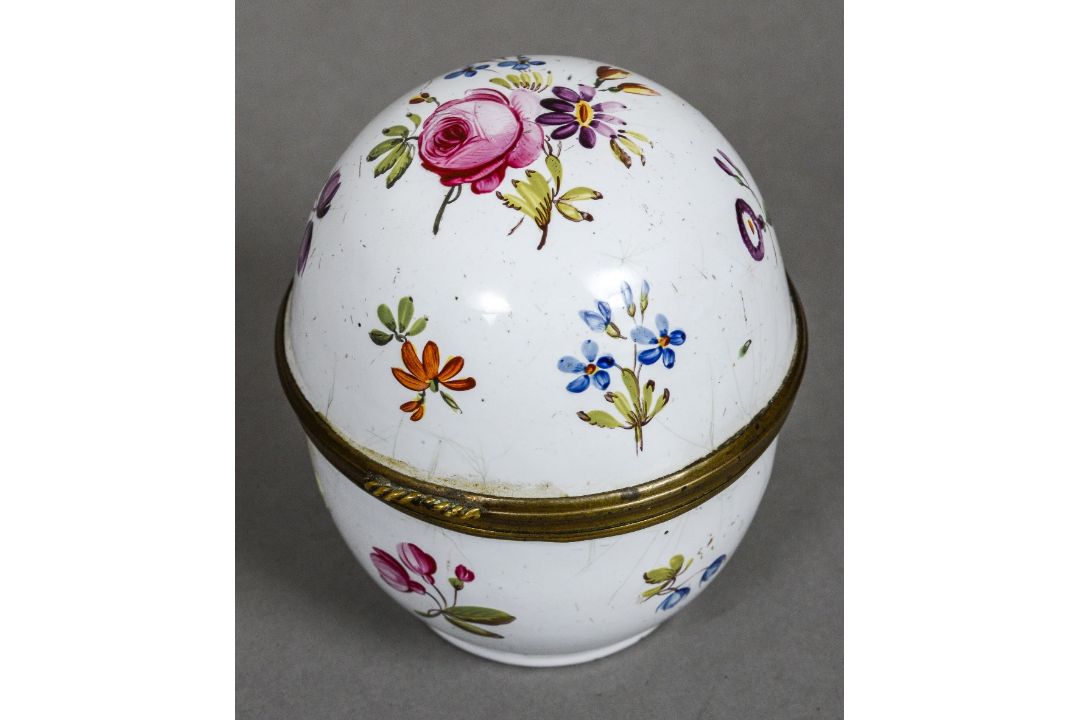 An 18th century enamelled table top pomander The hinged cover and body decorated with floral sprays,