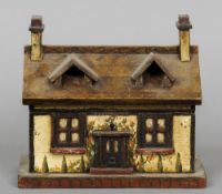 A Victorian painted tea caddy Formed as a cottage. 23 cm wide.