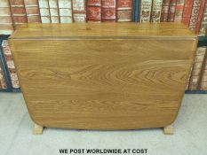 An Ercol light elm small drop leaf table (L68cm)