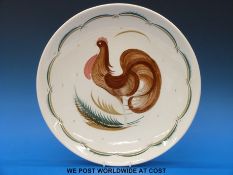 A large Susie Cooper wall plate decorated with a crowing cockerel (36cm diameter)
