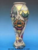 A Moorcroft vase decorated with hot air balloons dated 98 (28cm tall)