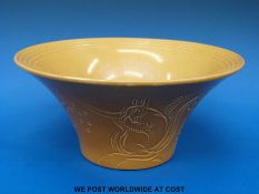 A Susie Cooper bowl with sgraffito decoration of squirrels on a mustard ground