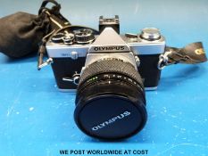 An Olympus OM-2N SLR camera fitted with a 55mm 1:1.2 Zuiko lens and a 1:2.